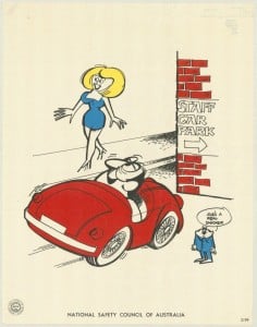 A humourous colour image of a male driver completely missing the entrance to a staff carpark because he is distracted by an attractive woman. 