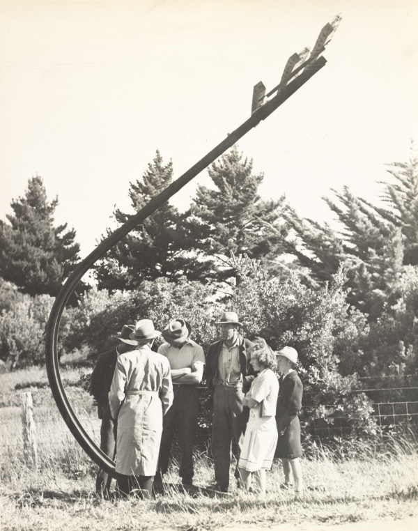 People look at a damaged telephone pole after an MG collided with it in 1947.