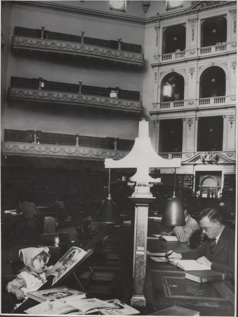 A 1950 photograph showing hows library users seated at desks.