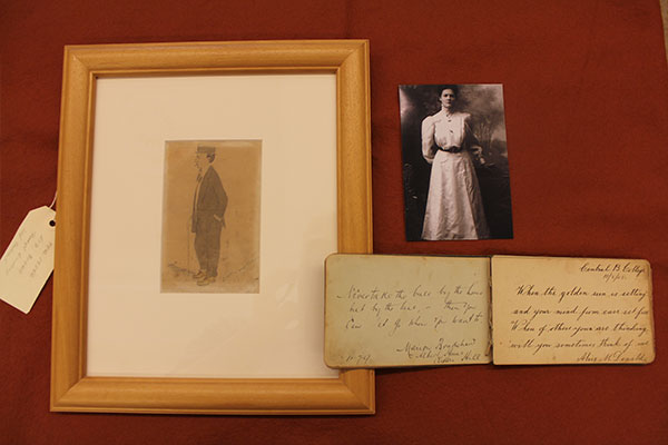 Image of drawing, autography book, and the owner