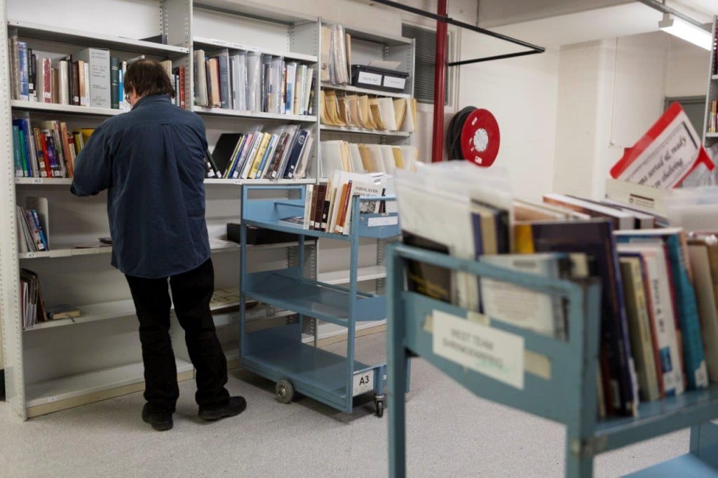 Image of a man sorting out books in the Library