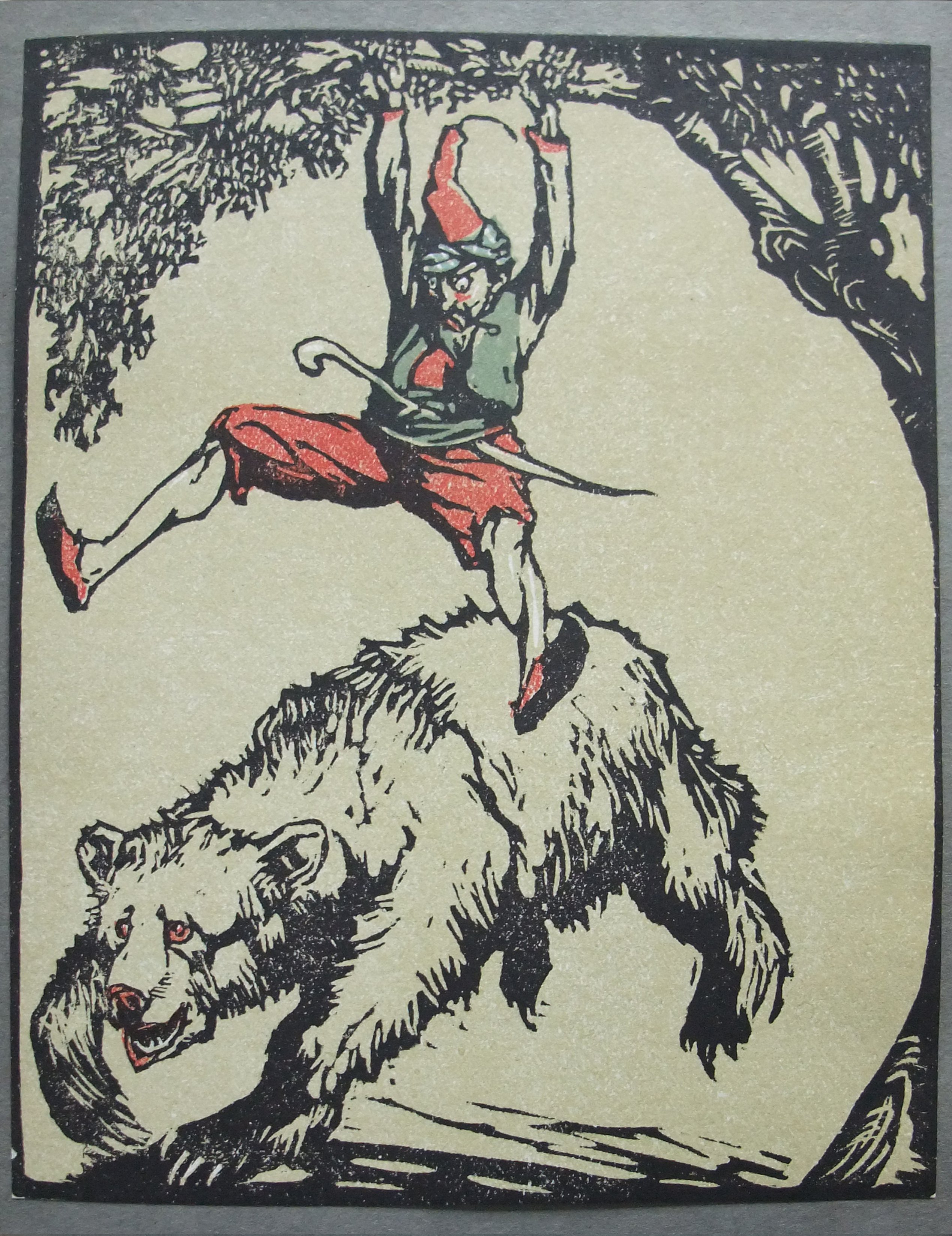 man hanging from tree above a bear