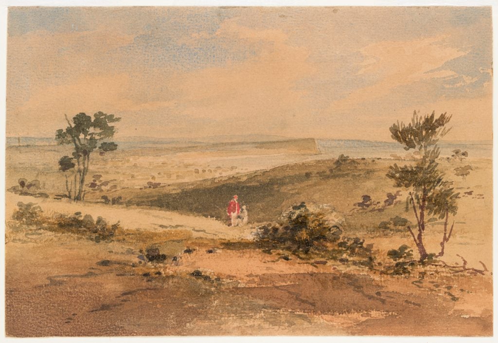 landscape showing bay and town in the distance. two human figures in the foreground.