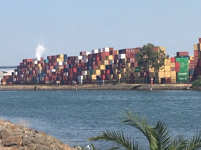 view across water shows stack of containers