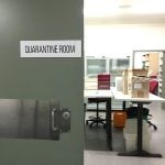 Half open sliding door with sign 'Quarantine Room'