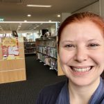 Portrait of woman in front of Library shelf