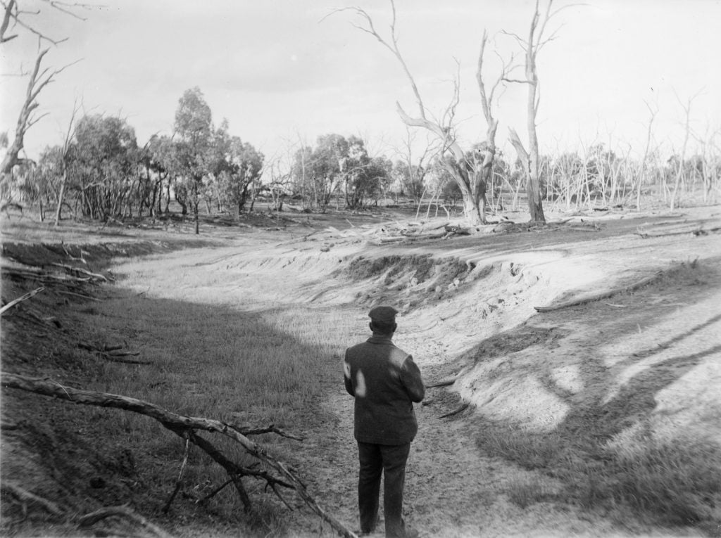 Photographs
Picture left- man standing in dry river bed.