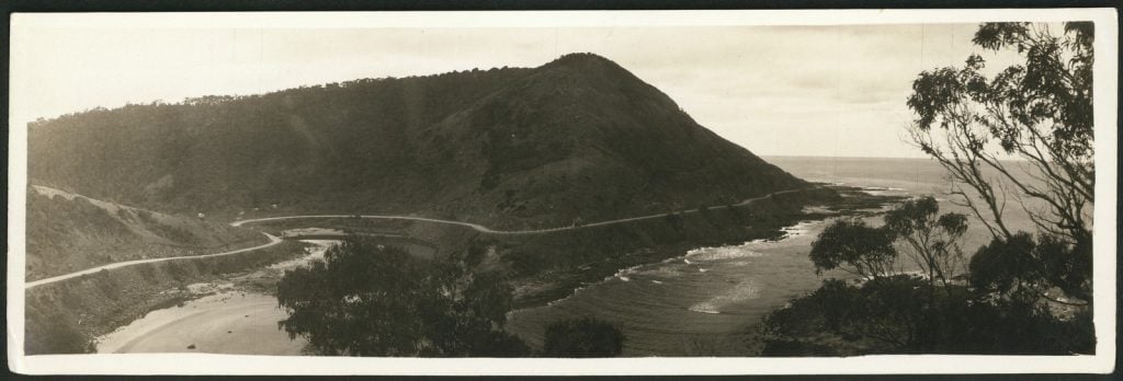 photograph, view of winding road along beaches, looking out to sea.