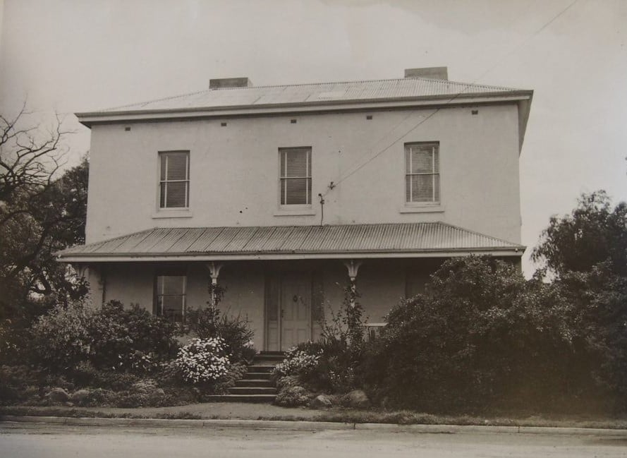 Black and white photo of two-storey house 