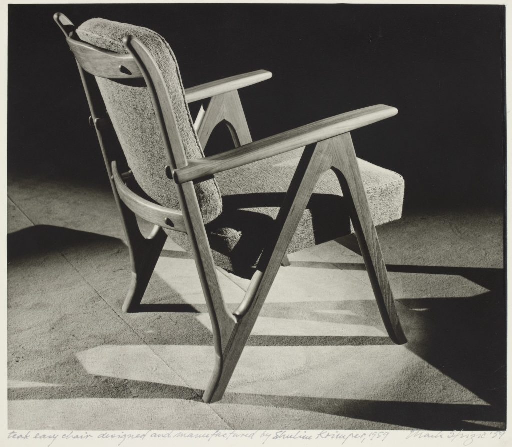 photograph of an arm chair, upholstered seat and back of chair - timber frame