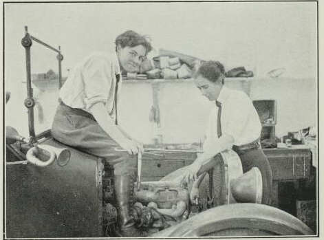 Black and white photo of two girls working on a car in Alice's garage