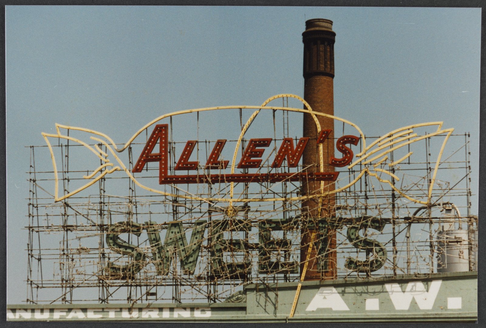 Photo of Allens Sweets sign on top of building 