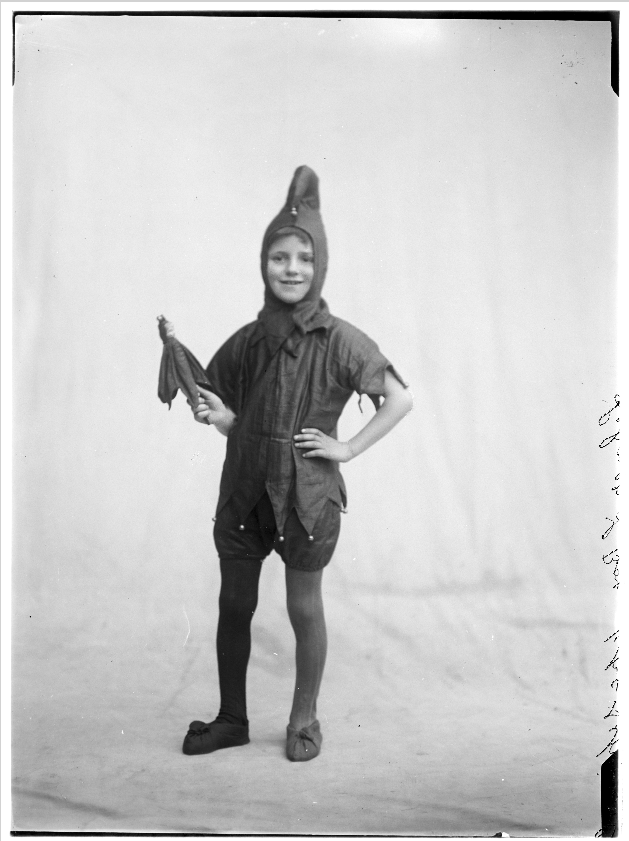 Studio portrait of a child dressed in a jester costume.