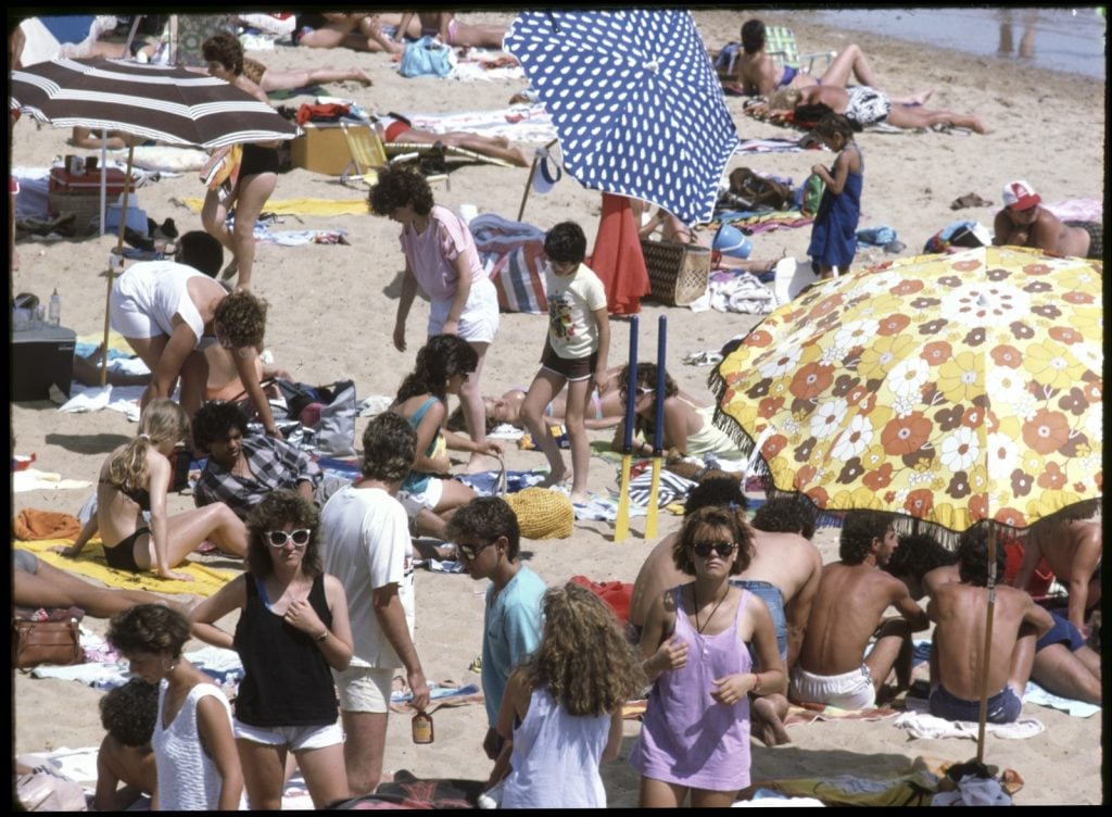 Crowded beach scene of beachgoers at Elwood beach, 