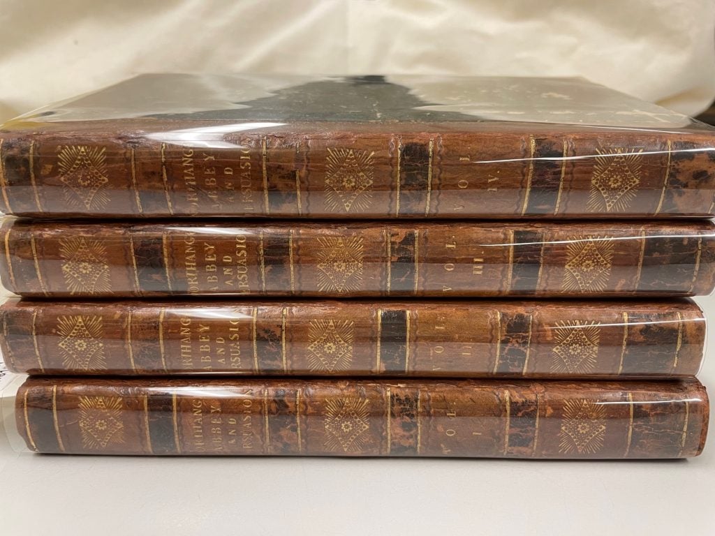 Photograph of spines of 4-volume set of Jane Austen's Northanger Abbey and Persuasion.
