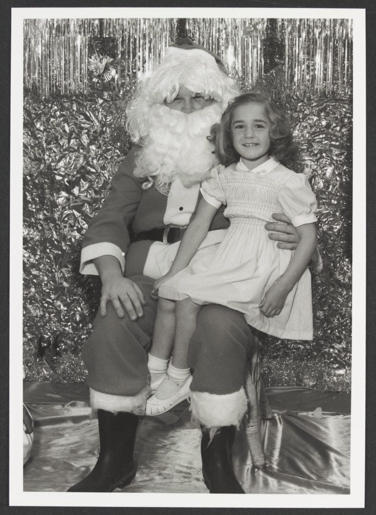 Girl sitting on Santa's knee at Coles Bourke Street Store No. 200