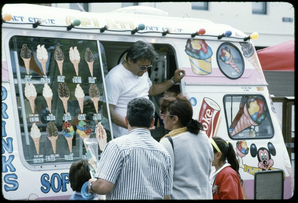 Photo of family purchasing ice creams from man in Mr Whippy van. 