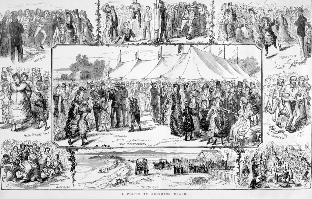 Picnic at Brighton Beach in 1880. A crowd of  people stand in front of a large marquee while a band plays. People enjoy luncheon at a long table. Adults and children take part in  races including a bag race and a  skipping race. Young men have a tug-of-war and there is a race for men over 40. 