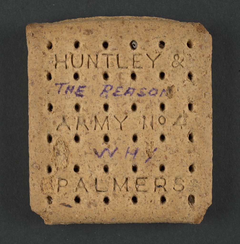 Front of an Army biscuit with the words "The reason why" handwritten onto it between the imprint "Huntley & Army No. 4 Palmers
