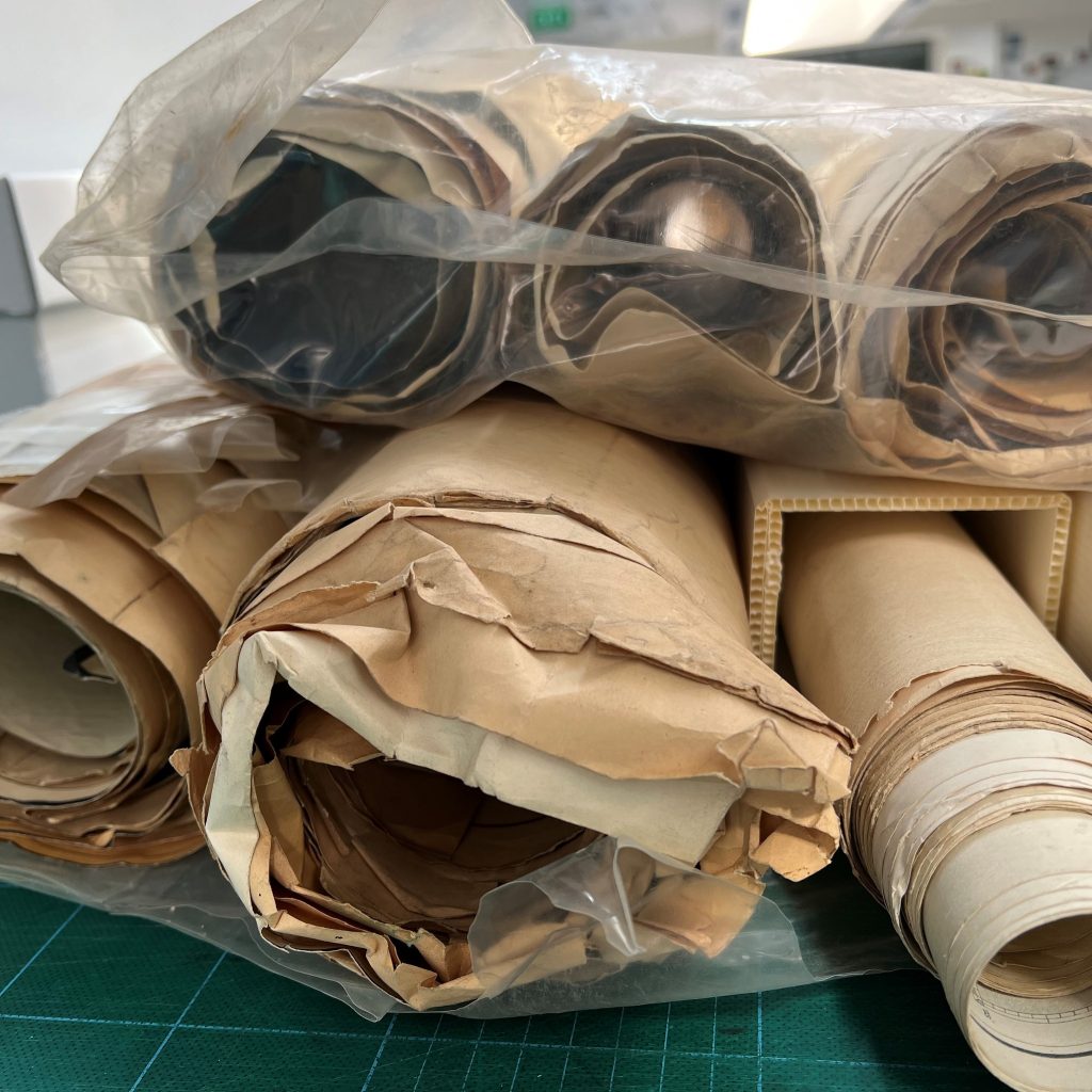 Several rolled maps prior to rehousing