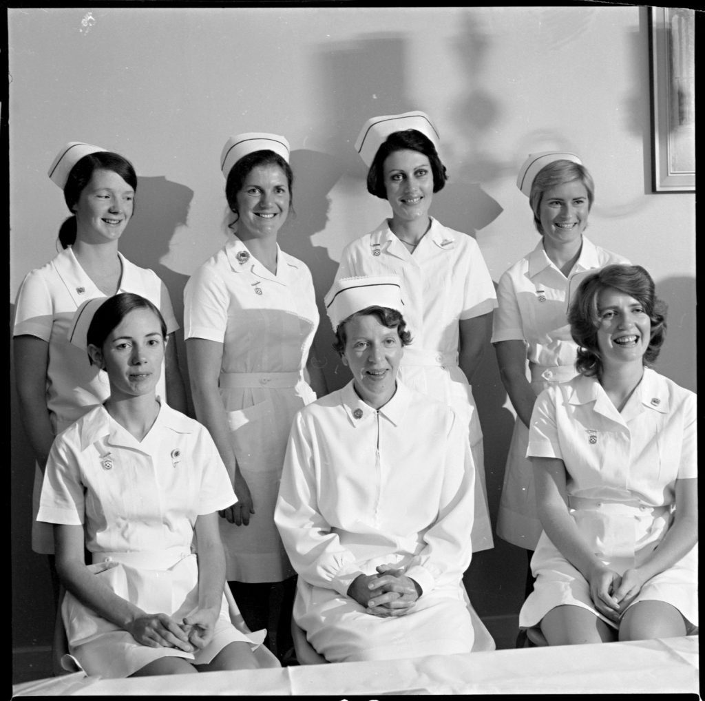 group photographic portrait of 7 young women graduating as midwives