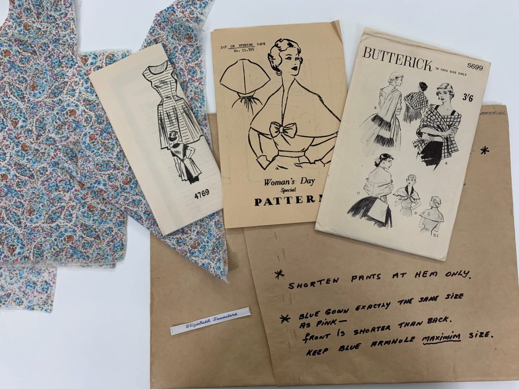 Vintage sewing patterns spread out on a tabletop
