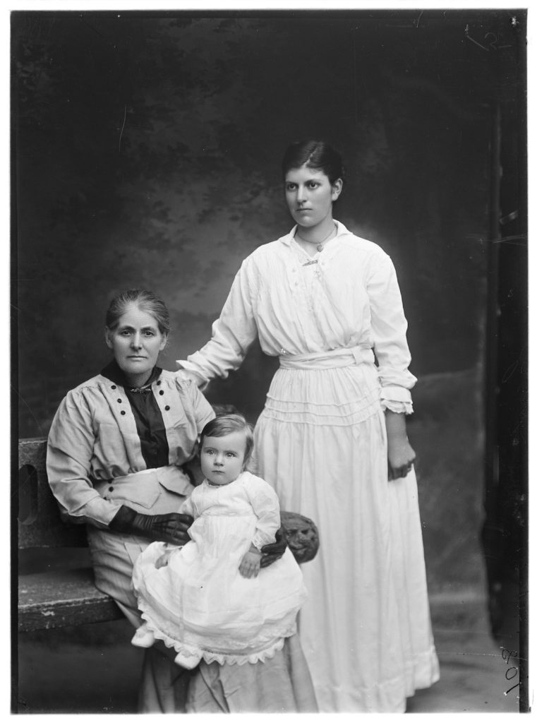 photographic portrait of two women - possibly grandmother, mother and a baby