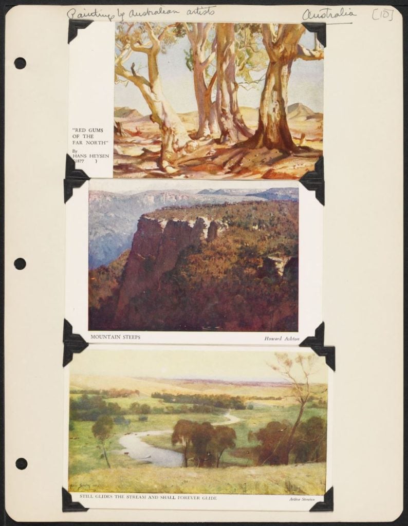 Page from scrapbook with three postcards stuck into it. All are colour watercolours of Australian landscapes. Page is headed 'Paintings by Australian artists" in handwriting. 