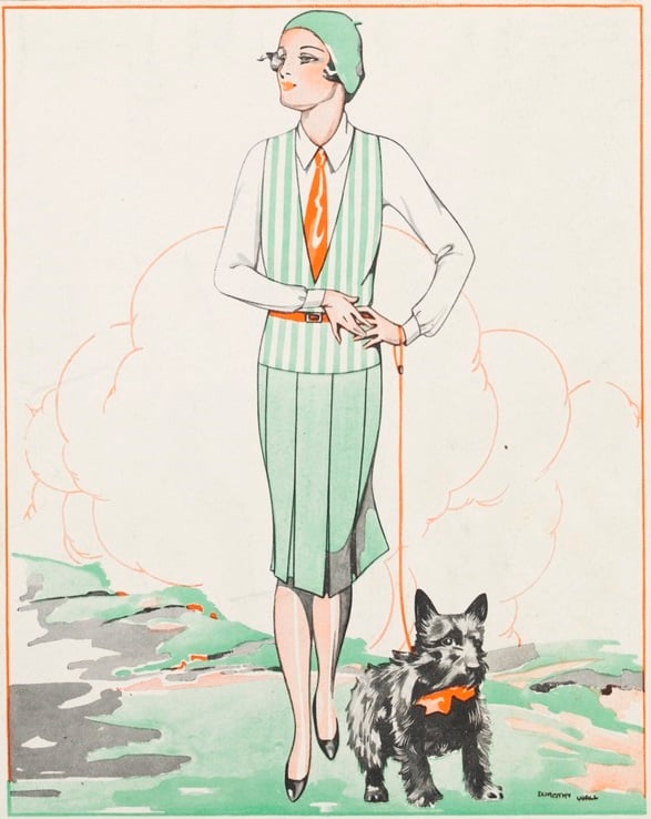 A woman wearing a suit walks a Scottish Terrier.