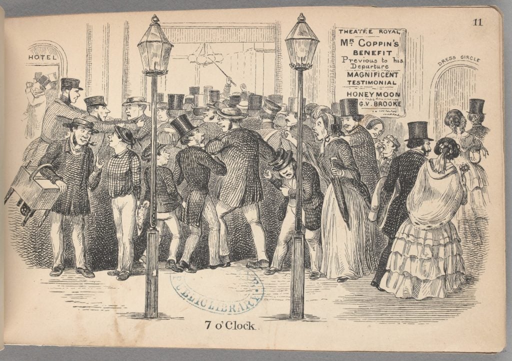 Shows the entrance to the Theatre Royal with a large crowd entering the building. Many are in formal dress, with the men in top hats.