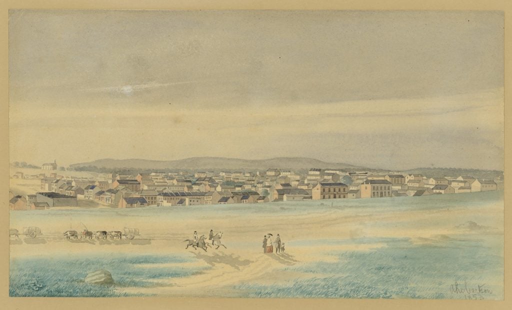 The view of Melbourne is from the Flagstaff Hill looking south east, showing St Peter's Church of England on Eastern Hill at the left and the Dandenongs on the horizon with the mass of Melbourne buildings in the centre. The following buildings are marked on the accompanying Key: 1 St. Peter's Church, 2 Latrobe Street, 3 Elizabeth Street, 4 St John's School House corner Elizabeth & Latrobe Streets, 5 Queen Street.