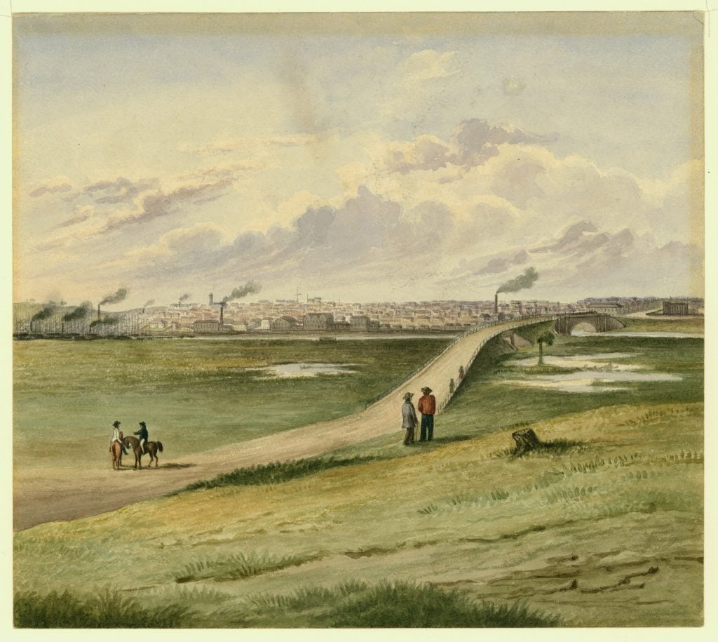 Watercolour shows the Lennox Bridge (now location of Princes Bridge) over the River Yarra, and its graded approach from the south side, with the city of Melbourne beyond. No buildings or structures are present on the south side of the Yarra River, just grassland with some figures and a man on the horse in the foreground.