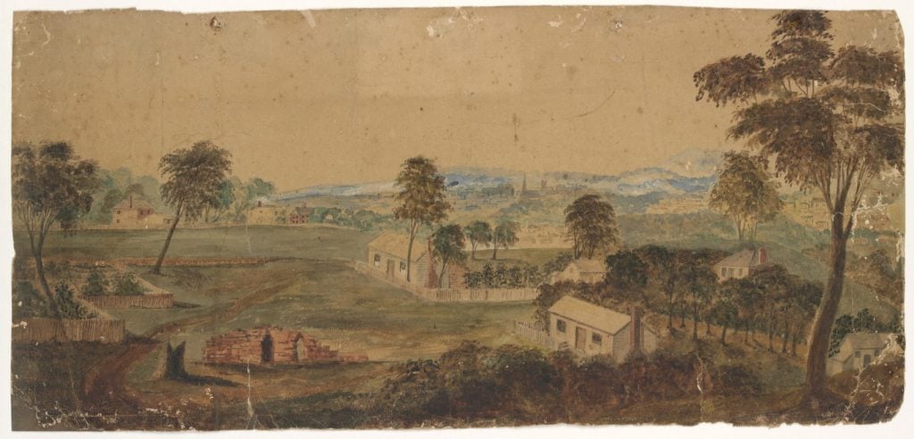 Shows the city of Melbourne from Eastern Hill, including Mount Macedon in the distance. A number of small cottages can be seen on what is now the land between Albert Street and Victoria Parade. A small stone building with gothic windows, in the course of construction, is the Baptist Chapel designed by John Gill in 1853. 