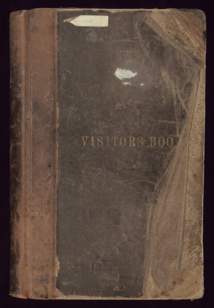 Brown leather bound book cover with 'visitors book' written in gold.