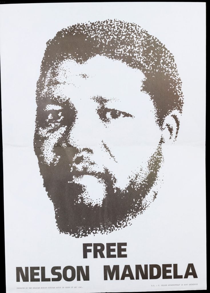 Black and white Free Nelson Mandela poster with face of a young black man with facial hair in centre.