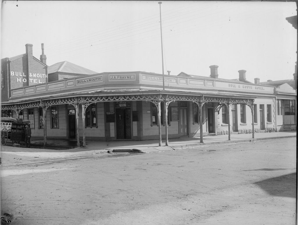 Black and white photo of the exterior of the Bull & Mouth Hotel on the corner of High Street and Nolan Street.