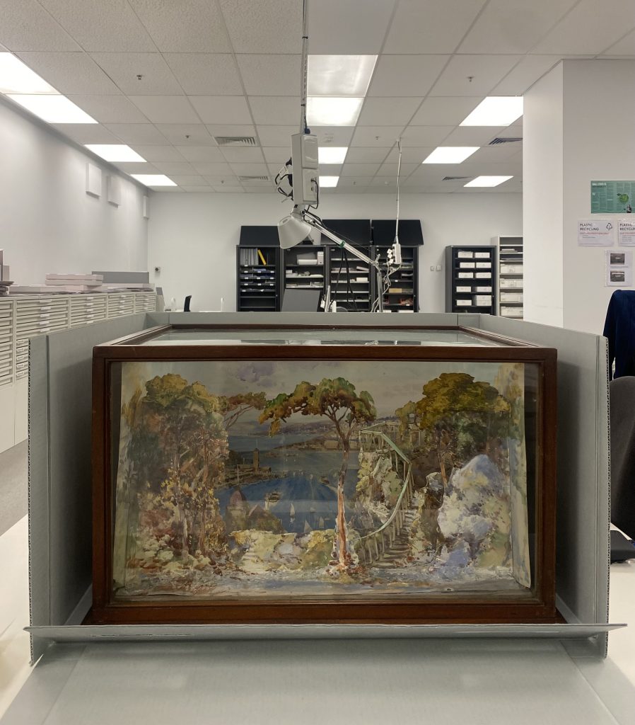 photograph of the model of the stage scenery - 3 dimensional cardboard model, with details hand painted in watercolor.