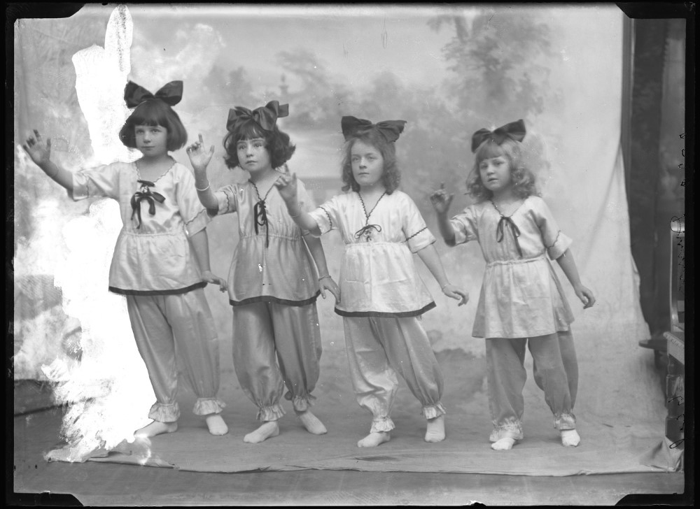 Four girls in bows posing