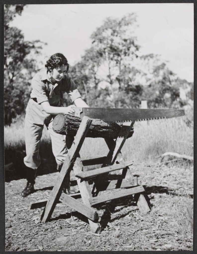 Woman sawing log