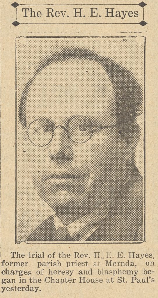 Newsprint portrait image of a dark-haired expressionless man, 'The Rev. H. E. Hayes', wearing thin-rimmed glasses in a suit jacket and tie.
The caption below reads: The trial of the Rev. H. E. E. Hayes, former parish priest at Mernda, on charges of heresy and blasphemy began in the Chapter House at St. Paul's yesterday.