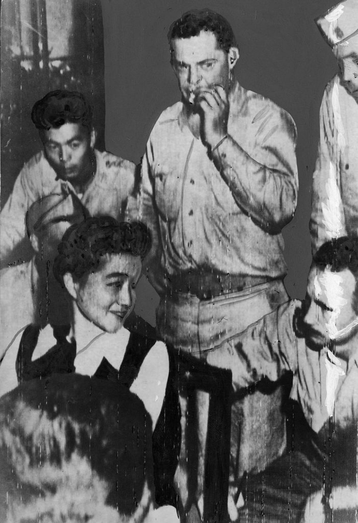 Iva Toguri being interviewed by American media correspondents in Japan. She sits on a chair surrounded by journalists.