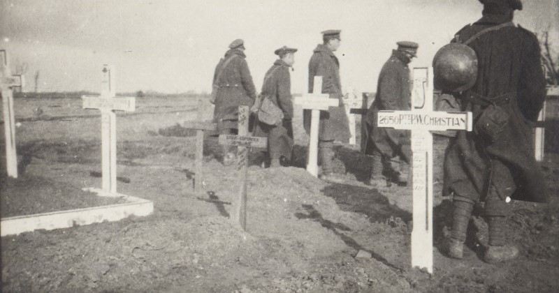 Soldiers standing near crosses for graves