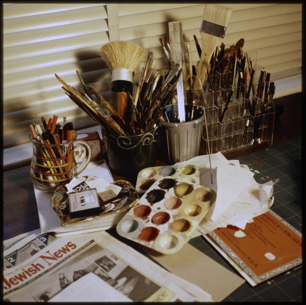 A photo of the material used by Fay Plamka to create her artwork including paint brushes and a paint pallet