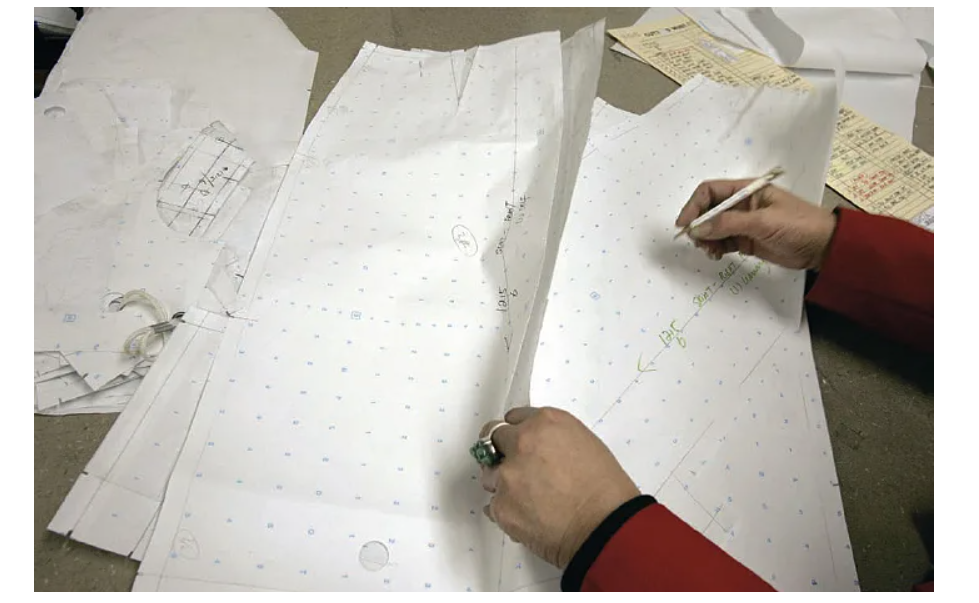 Pattern being drawn on cut paper pieces