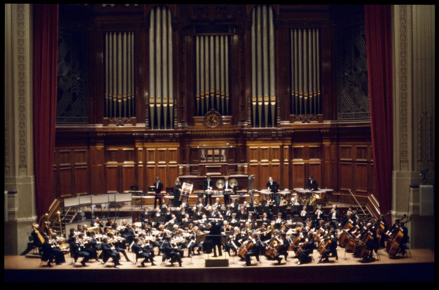 Photo of Melbourne Symphony Orchestra on stage at the Melbourne Town Hall in the front of the pipe organ.