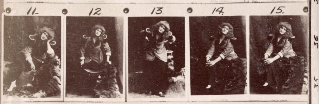 A set of 5 photographic proofs featuring actress Edith Crane dressed as her character Trilby. She is seated and wearing a military coat with fringed epaulettes, a long striped skirt and no shoes. She has a blunt fringe and her hair is out and falling on her shoulders.  In some images she is sitting on a tiger-skin rug.