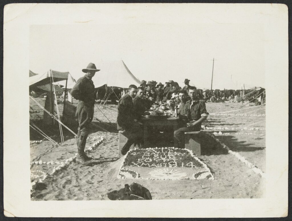 Soldiers sitting outside, celebrating Christmas
