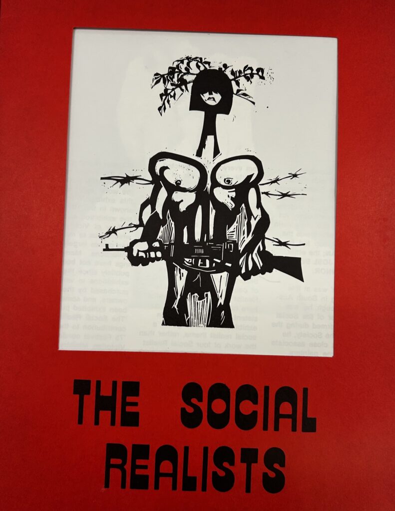 Photograph of the cover of the Social Realists exhibition catalogue, showing graphic of soldier with gun, with red surround.