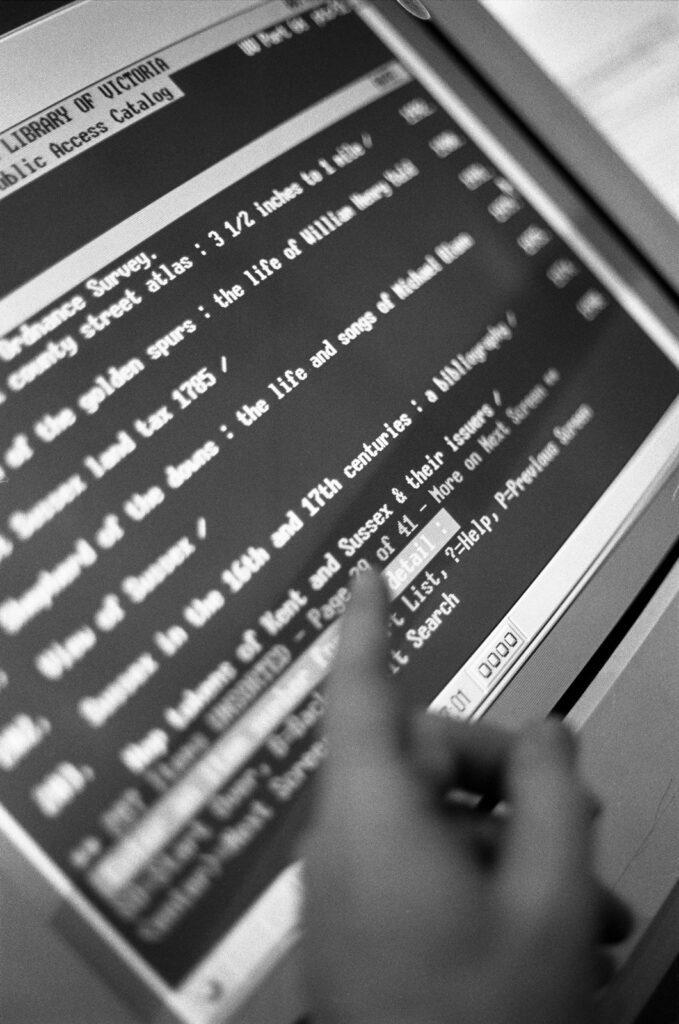 Close up of black and white screen showing an early iteration of the digital library catalogue. Test is white on a black background.