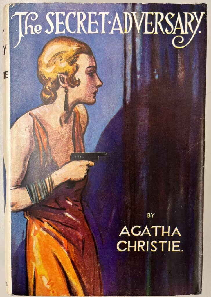 cover of The Secret Adversary. cover shows blonde woman in orange dress from side on holding a gun.